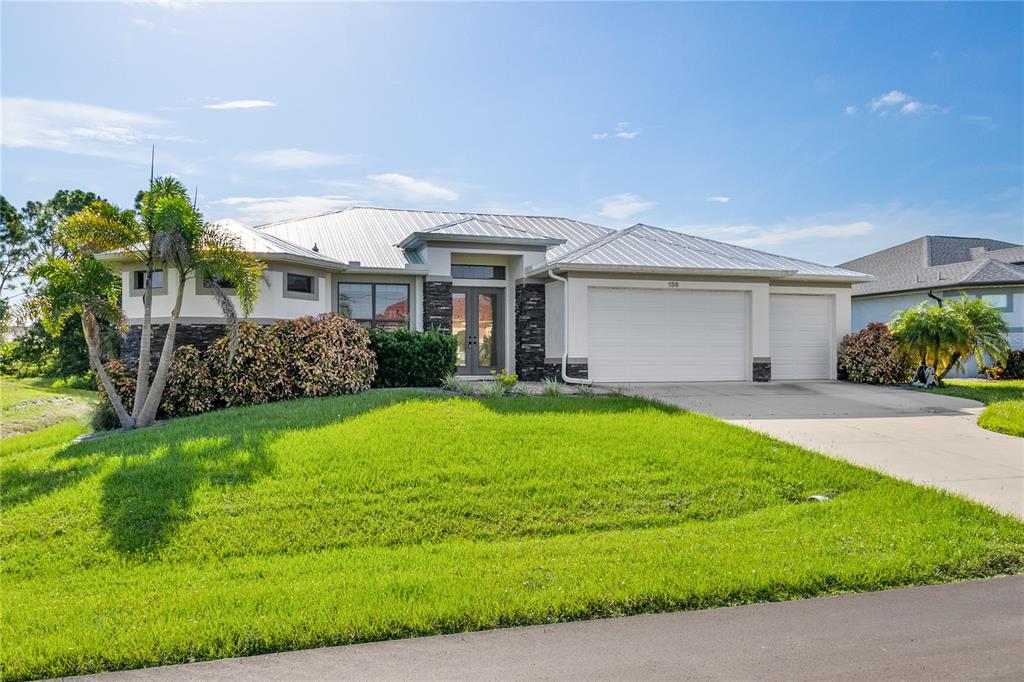 150 Tournament Road Rotonda West, FL 33947 - Photo 1 of 1 a view of a house with backyard and garden