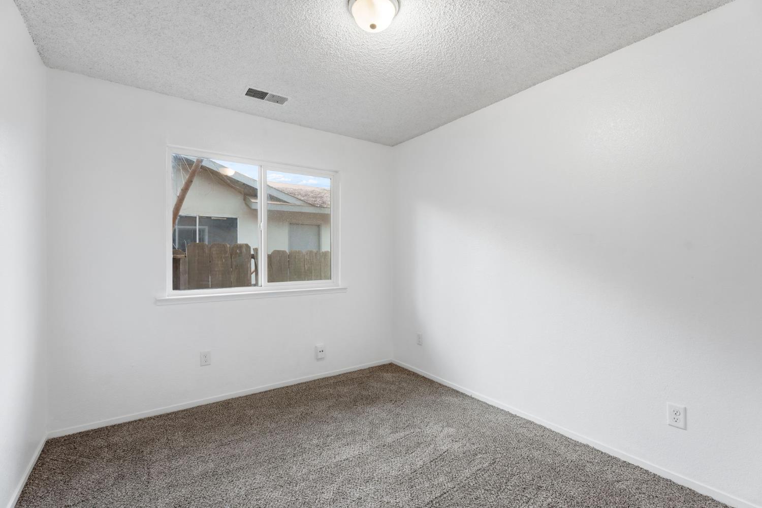 237 East Modoc Avenue Visalia, CA 93291 - Photo 13 of 31 an empty room with a window