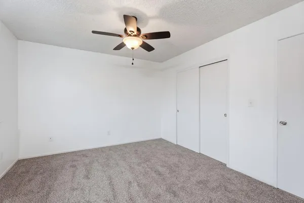 a view of a room with a ceiling fan