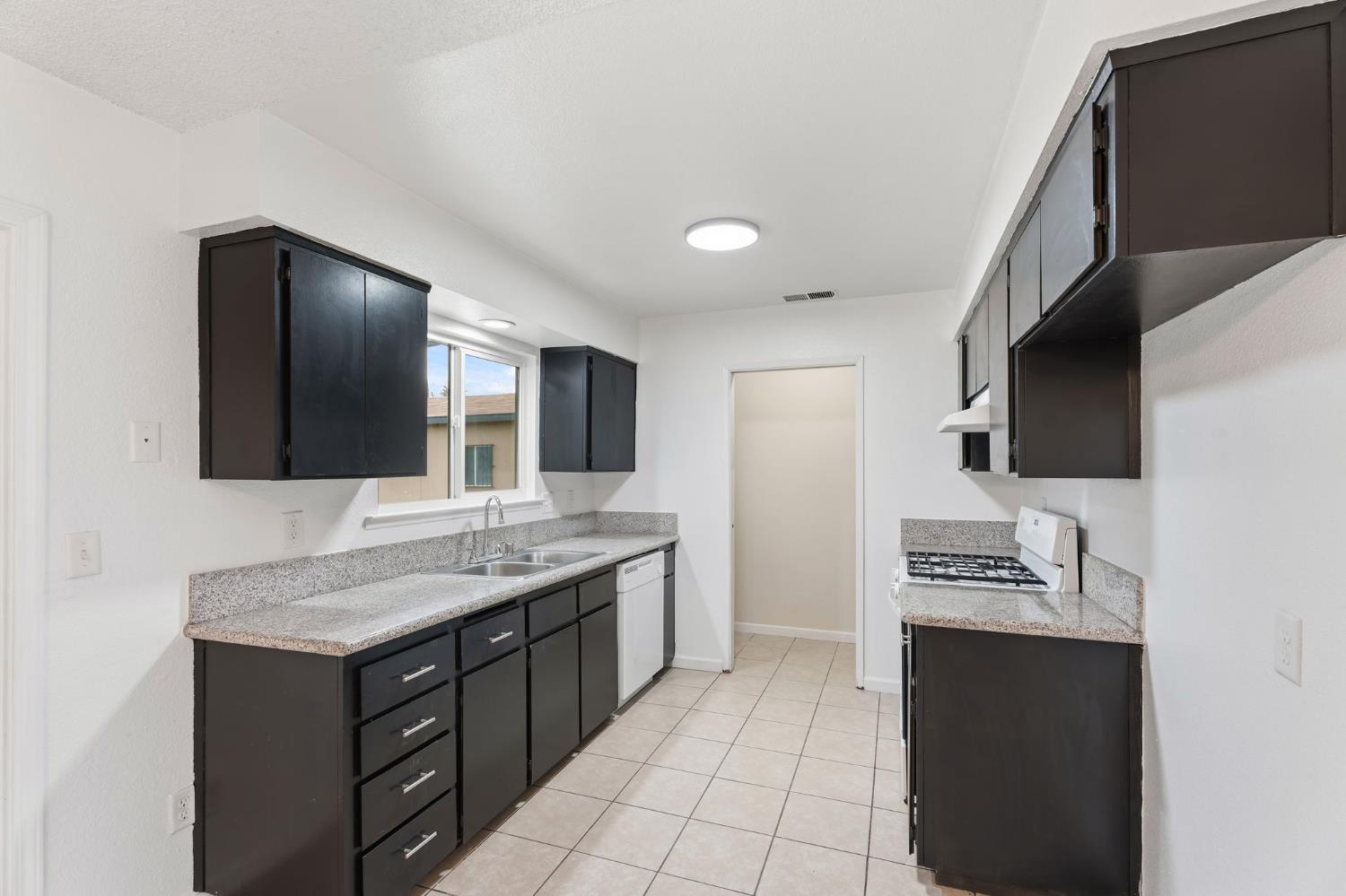 237 East Modoc Avenue Visalia, CA 93291 - Photo 2 of 31 a bathroom with a granite countertop sink and a mirror