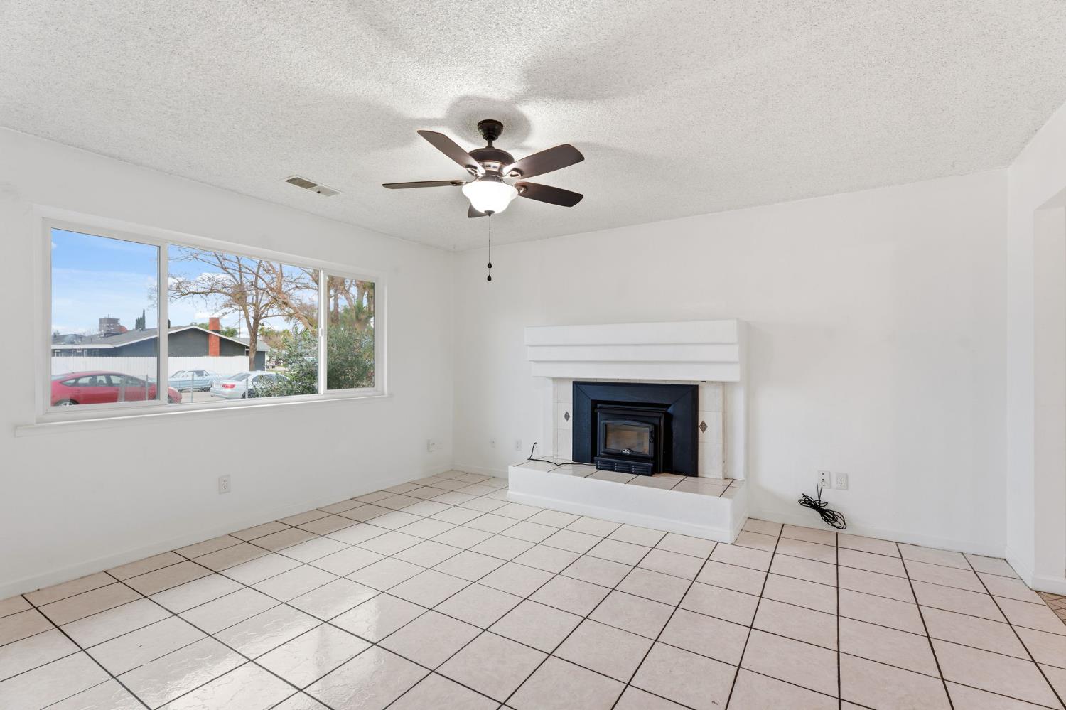 237 East Modoc Avenue Visalia, CA 93291 - Photo 29 of 31 a view of an empty room with window and chandelier fan