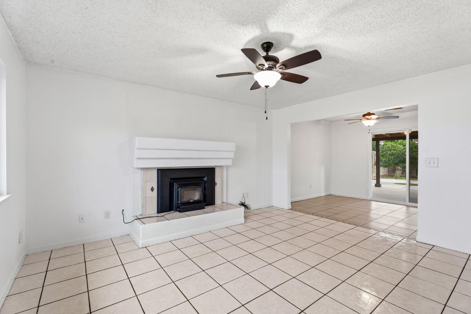 237 East Modoc Avenue Visalia, CA 93291 - Photo 30 of 31 a view of an empty room with window and chandelier fan