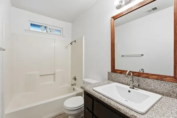 a view of a kitchen with a sink and a window