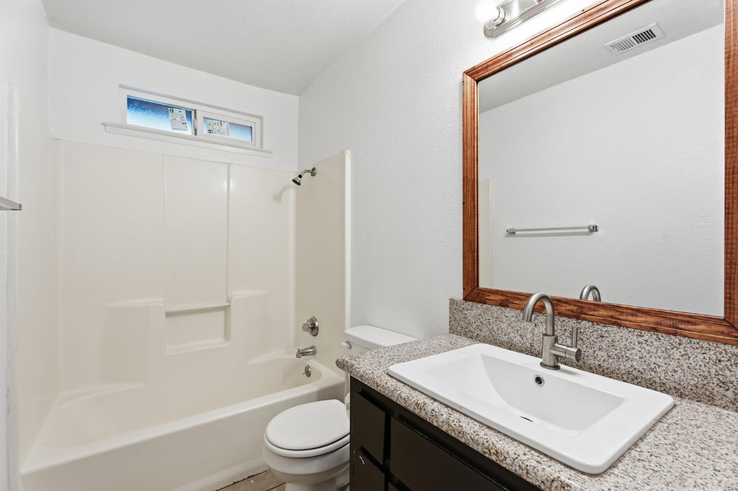 237 East Modoc Avenue Visalia, CA 93291 - Photo 5 of 31 a bathroom with a sink a toilet and shower