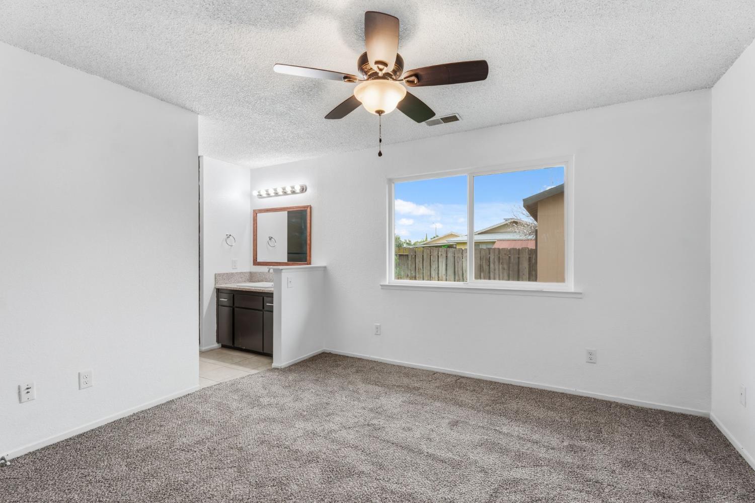 237 East Modoc Avenue Visalia, CA 93291 - Photo 6 of 31 a view of a kitchen with a sink and a window