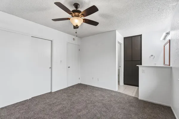 a view of a room with a ceiling fan