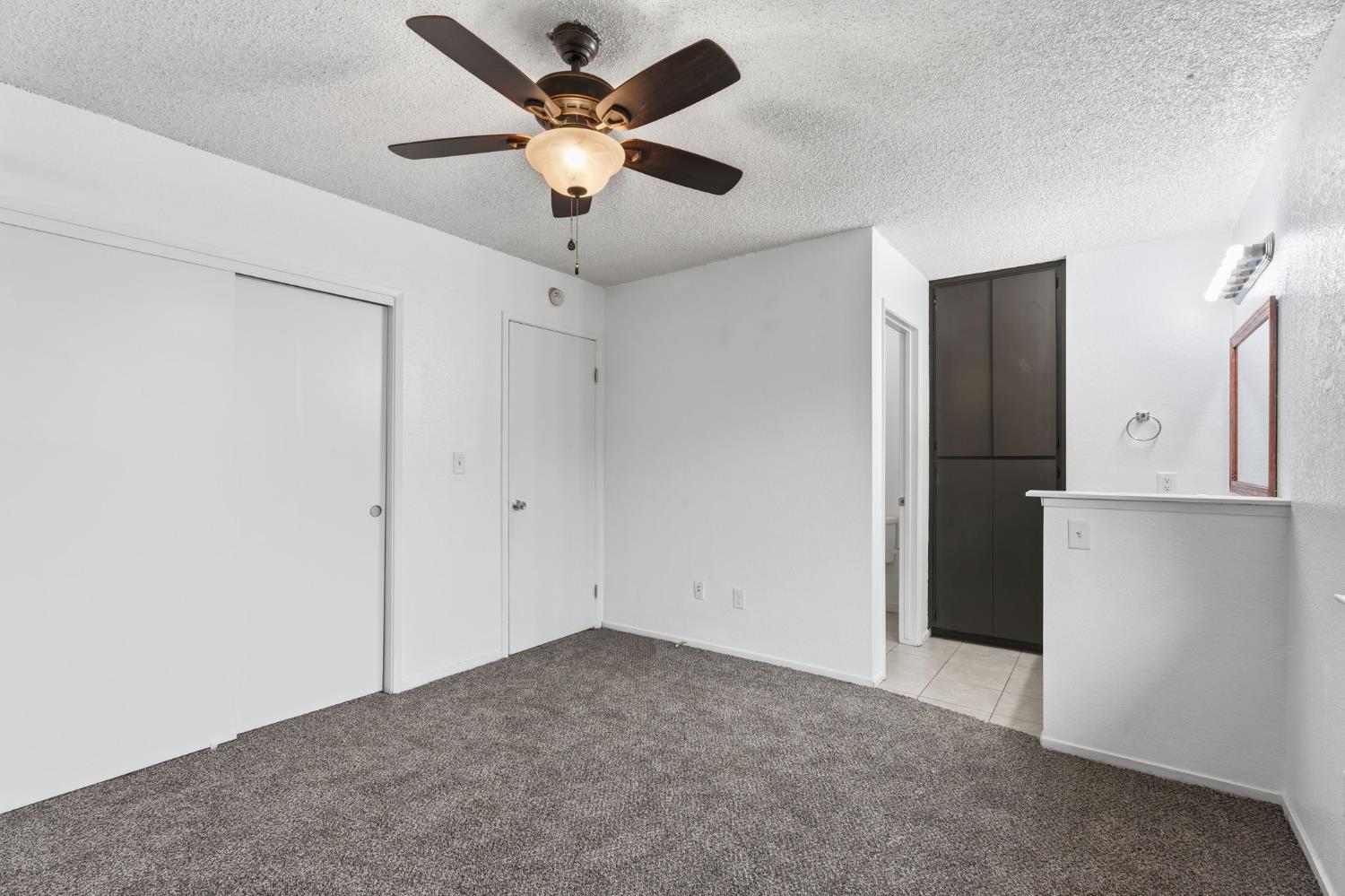 237 East Modoc Avenue Visalia, CA 93291 - Photo 7 of 31 an empty room with a window and a ceiling fan