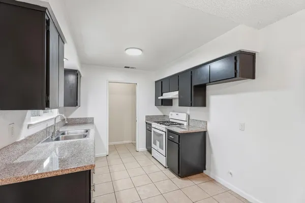 a kitchen with a sink cabinets and stainless steel appliances