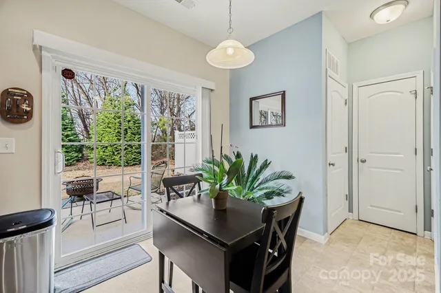 a dining room with furniture and large window