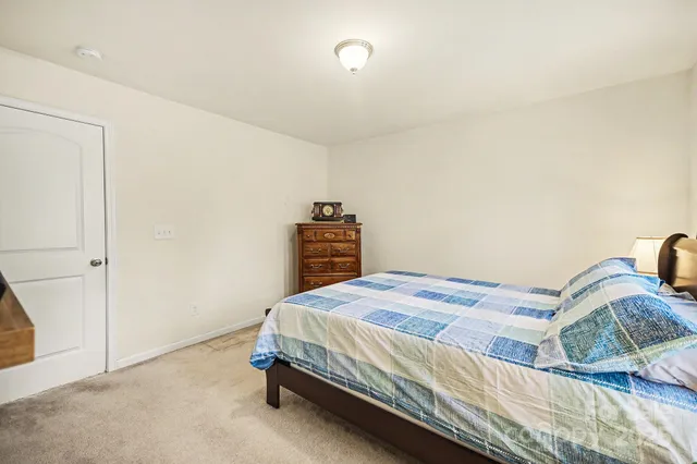 a bedroom with a bed and dresser