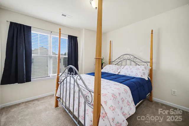 a bedroom with two beds and a window