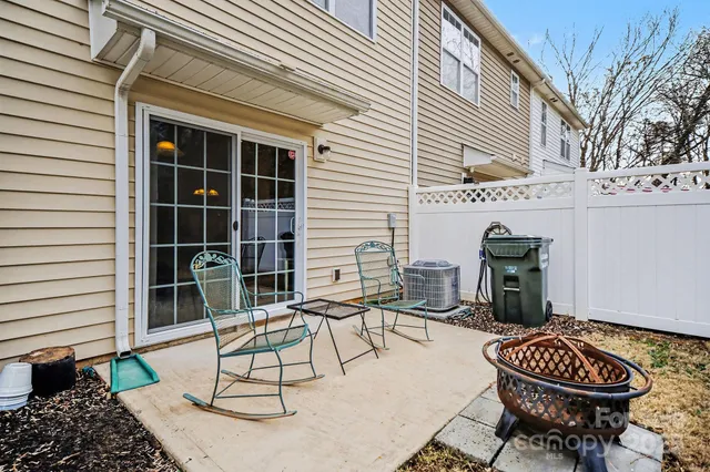 a view of a chair and table in backyard