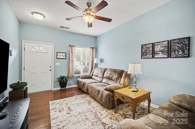 a living room with furniture and wooden floor