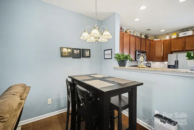 a kitchen with a table and a refrigerator