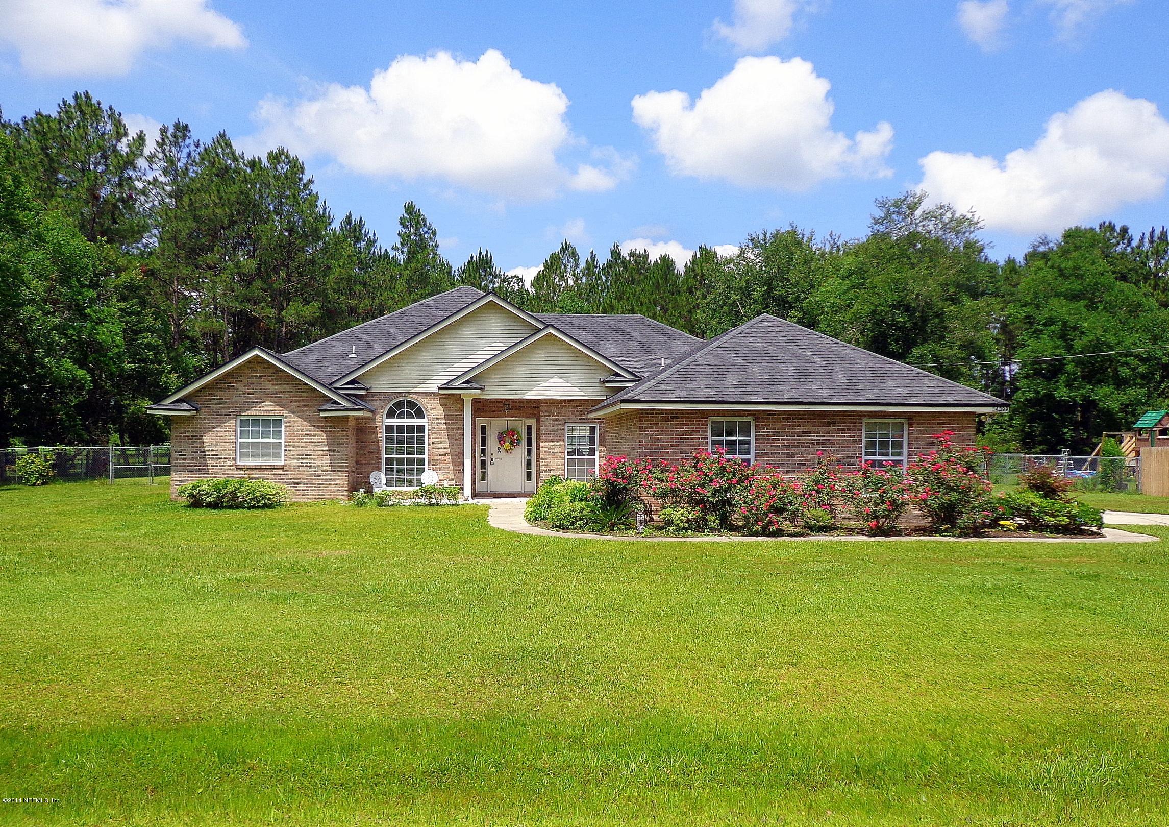54399 Church Road Callahan, FL 32011 - Photo 1 of 49 a view of a house with garden