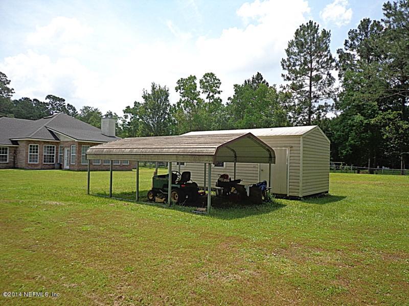 54399 Church Road Callahan, FL 32011 - Photo 11 of 49 a view of a house with backyard and sitting area