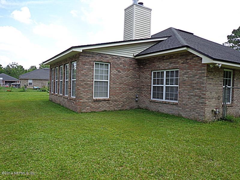 54399 Church Road Callahan, FL 32011 - Photo 18 of 49 a front view of a house with garden