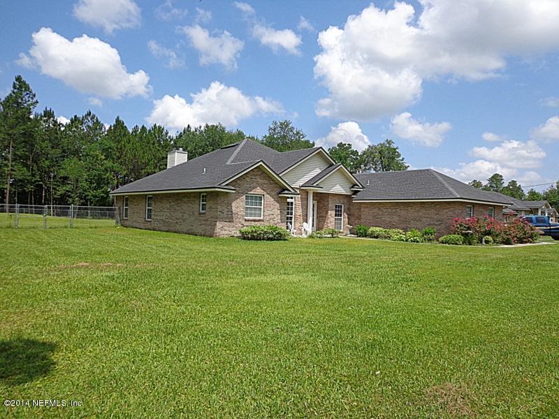 54399 Church Road Callahan, FL 32011 - Photo 2 of 49 a front view of house with yard and green space