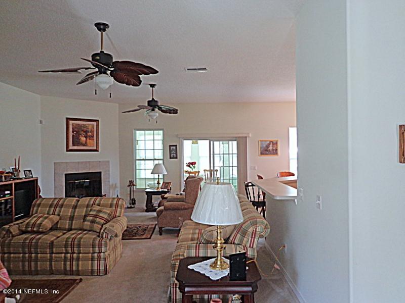 54399 Church Road Callahan, FL 32011 - Photo 24 of 49 a living room with furniture a fireplace and a window