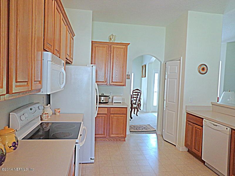54399 Church Road Callahan, FL 32011 - Photo 27 of 49 a kitchen with stainless steel appliances granite countertop a refrigerator and a sink