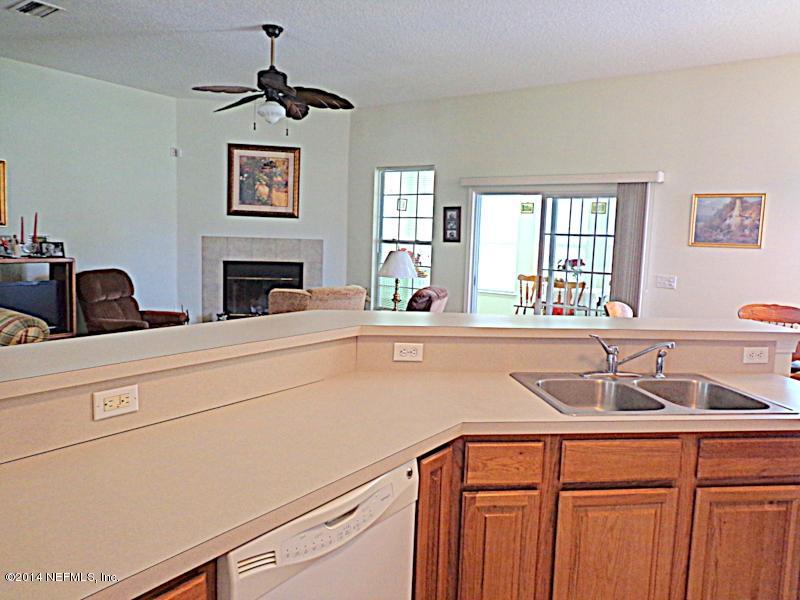 54399 Church Road Callahan, FL 32011 - Photo 29 of 49 a kitchen with a sink and a refrigerator