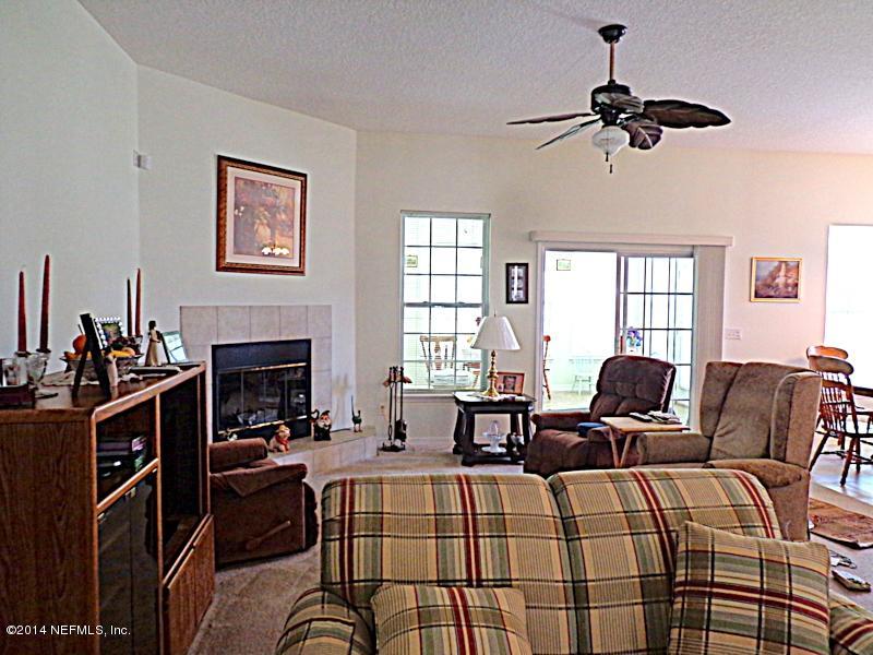 54399 Church Road Callahan, FL 32011 - Photo 30 of 49 a living room with furniture fireplace and a window