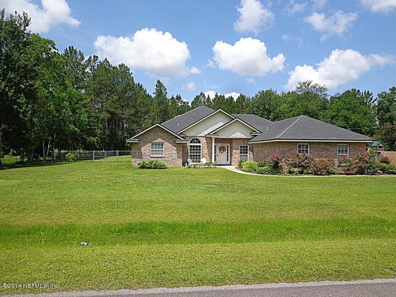 54399 Church Road Callahan, FL 32011 - Photo 3 of 49 a front view of a house with garden