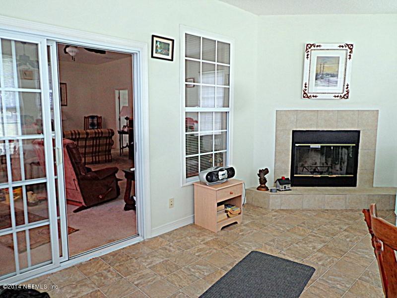 54399 Church Road Callahan, FL 32011 - Photo 33 of 49 a living room with furniture and a fireplace