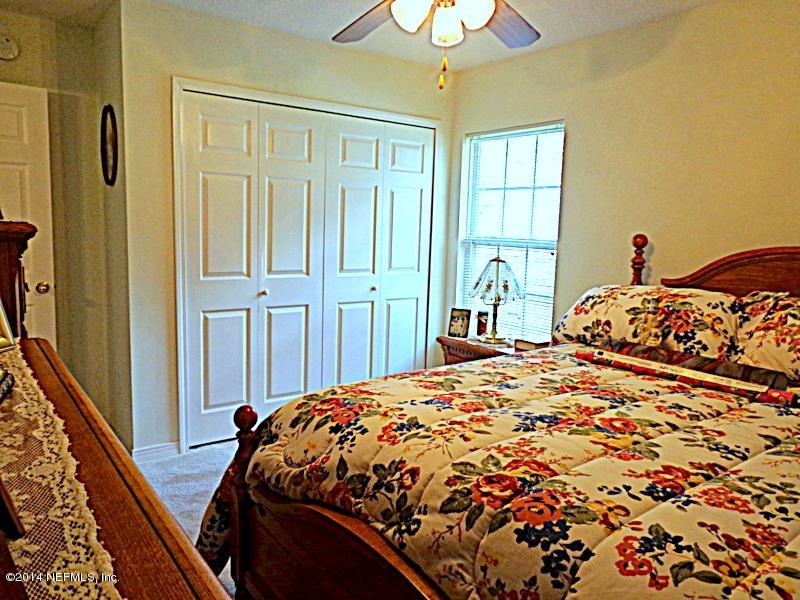 54399 Church Road Callahan, FL 32011 - Photo 45 of 49 a bed sitting in a bedroom next to a window