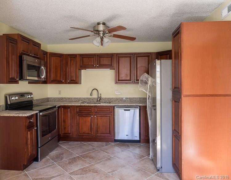 9712 Fairway Ridge Road Charlotte, NC 28277 - Photo 4 of 12 a kitchen with stainless steel appliances granite countertop a refrigerator and a sink