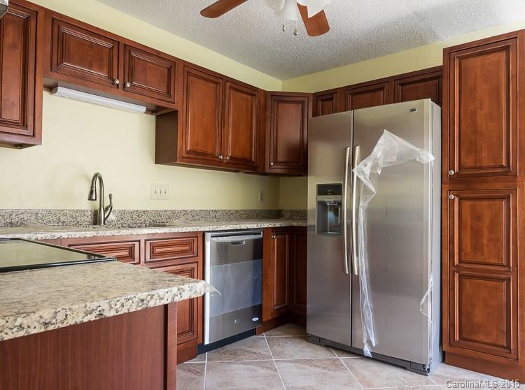 9712 Fairway Ridge Road Charlotte, NC 28277 - Photo 5 of 12 a kitchen with stainless steel appliances granite countertop a refrigerator and a sink