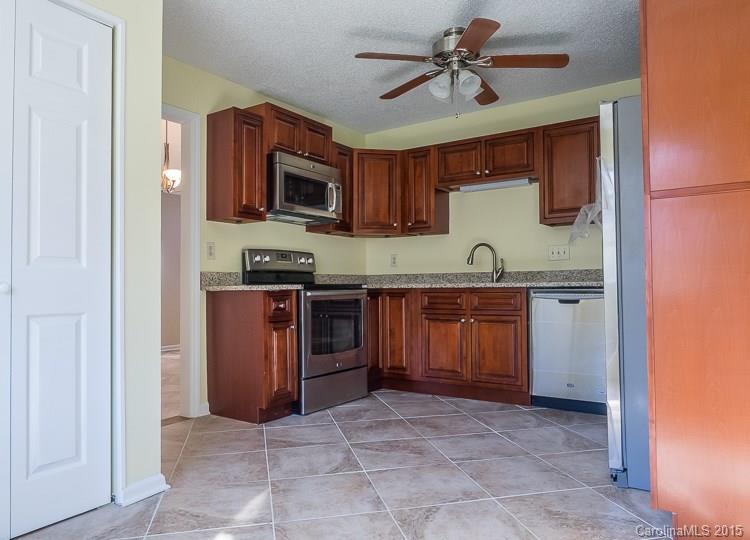 9712 Fairway Ridge Road Charlotte, NC 28277 - Photo 6 of 12 a kitchen with stainless steel appliances granite countertop a stove and a sink
