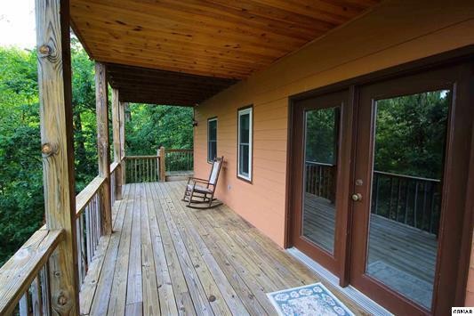 1045 Bryan View Road Sevierville, TN 37862 - Photo 19 of 21 a view of roof deck with wooden floor and roof with floor to ceiling window