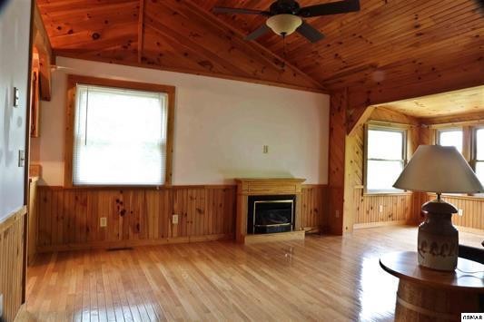 1045 Bryan View Road Sevierville, TN 37862 - Photo 9 of 21 a view of an empty room with wooden floor fireplace and a window