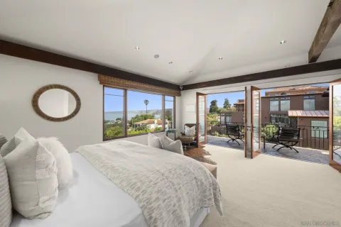 a bed room with a bed and a large window