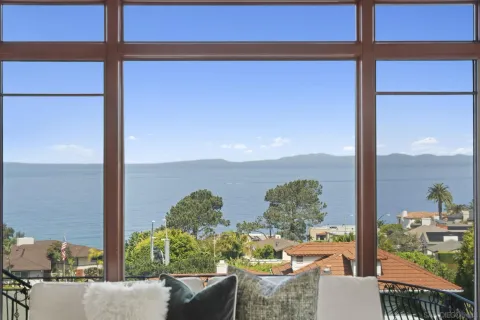 a view of a balcony with chair and a couple of potted plants