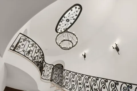 a view of a hallway with paintings on the wall