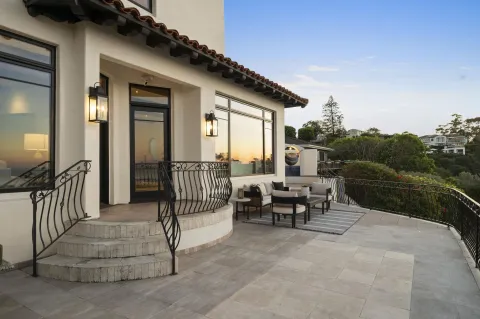 a view of a porch with furniture and garden