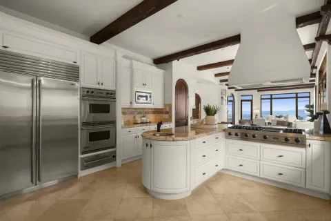 a kitchen with granite countertop a sink and stainless steel appliances