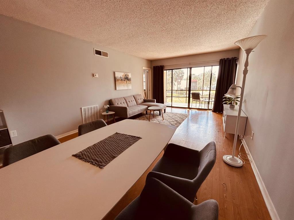 2050 Oleander Boulevard, Unit 703 Fort Pierce, FL 34950 - Photo 14 of 25 a bed room with a bed couches and a flat tv screen