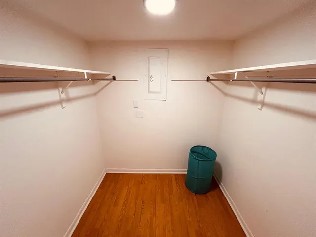 a view of a hallway with racks on the wall