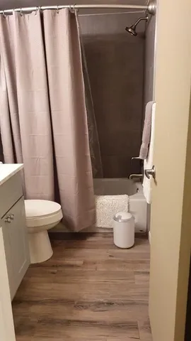 a white toilet sitting next to a sink