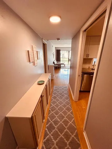 a hallway with furniture and a fireplace