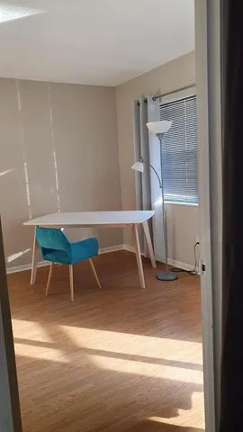 a view of a room with wooden floor and white walls
