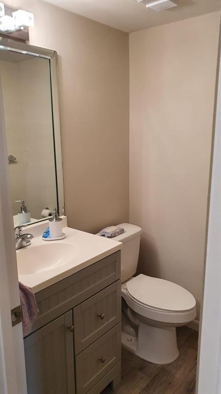 2050 Oleander Boulevard, Unit 703 Fort Pierce, FL 34950 - Photo 25 of 25 a bathroom with a sink a toilet and mirror