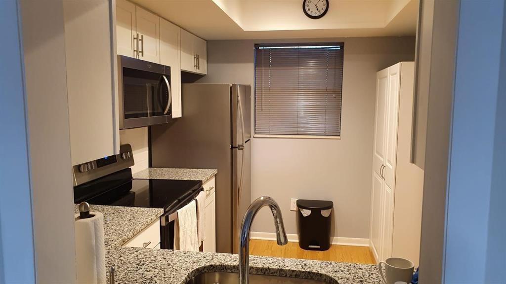 2050 Oleander Boulevard, Unit 703 Fort Pierce, FL 34950 - Photo 5 of 25 a kitchen with a refrigerator and a sink