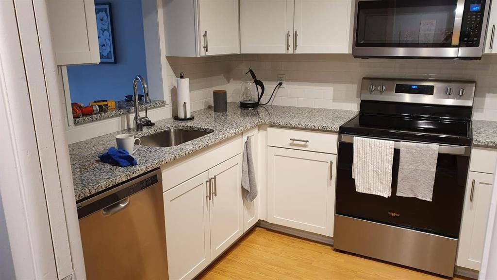 2050 Oleander Boulevard, Unit 703 Fort Pierce, FL 34950 - Photo 6 of 25 a kitchen with stainless steel appliances granite countertop a stove a sink and a microwave