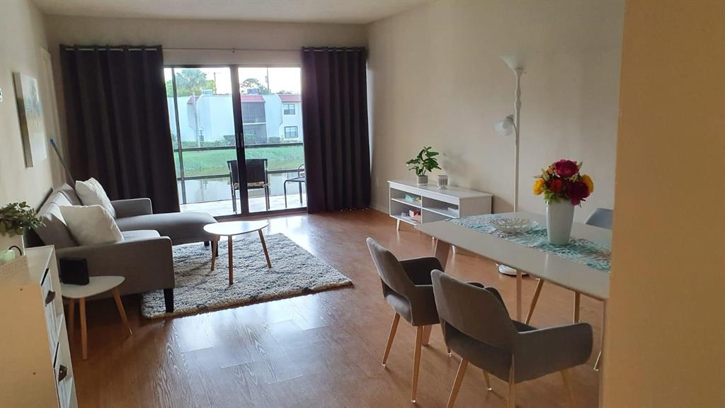 2050 Oleander Boulevard, Unit 703 Fort Pierce, FL 34950 - Photo 10 of 25 a living room with furniture and a window