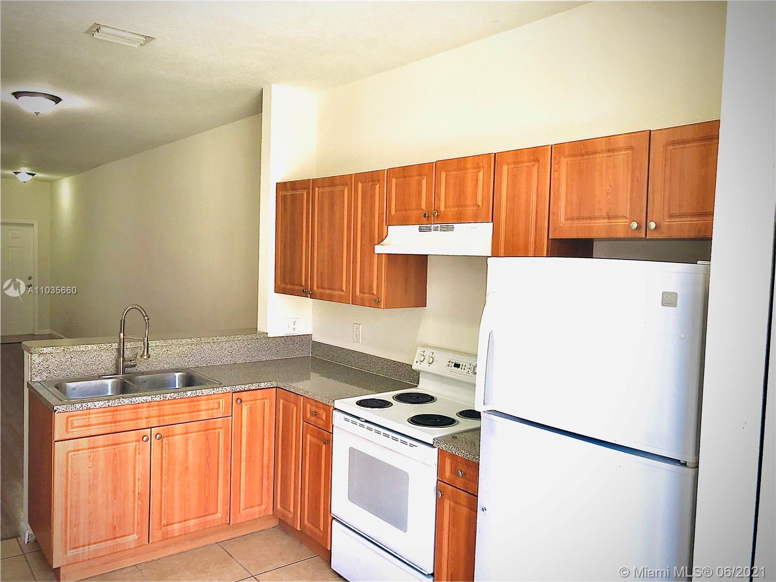 25 Southwest 15th Road, Unit 25 Homestead, FL 33030 - Photo 4 of 15 a kitchen with a refrigerator sink and stove