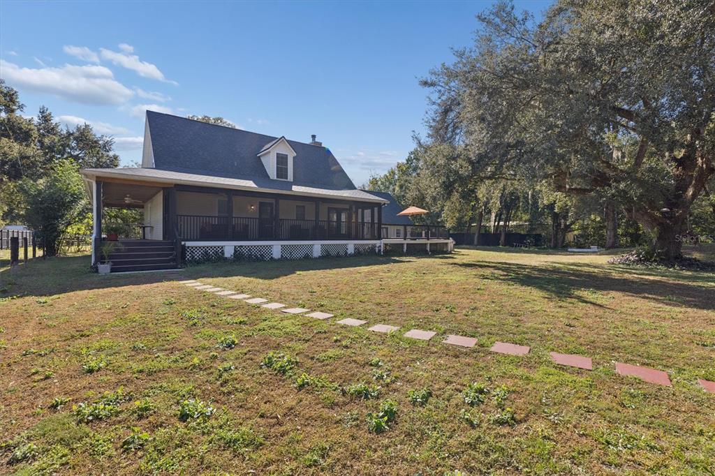 16607 Bearle Road Orlando, FL 32828 - Photo 13 of 57 a view of swimming pool with a yard and tree in the background
